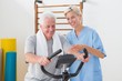 © WavebreakmediaMicro - Senior man doing exercise bike with therapist