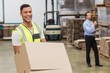 © WavebreakmediaMicro - Smiling warehouse worker moving boxes on trolley