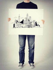 Wall Mural - man showing white board with city sketch