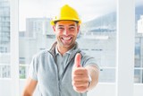 Fototapeta  - Manual worker gesturing thumbs up in building