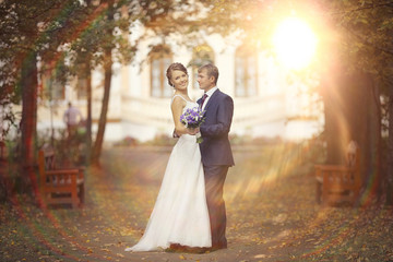 Wall Mural - bride and groom in autumn park Love Life