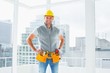 © WavebreakMediaMicro - Smiling handyman standing in building