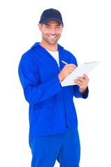 Poster - Portrait of happy male mechanic writing on clipboard
