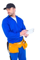 Poster - Handyman in blue overall writing on clipboard
