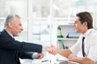 © Friends Stock - Two businessmen shaking hands in office