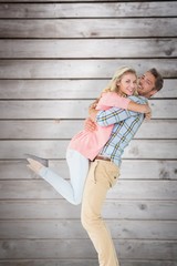 Poster - Handsome man picking up and hugging his girlfriend