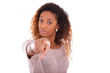 Wall Mural - Unhappy young african american pointing finger isolated on white