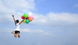 © lzf - young asian woman jumping with colored balloons