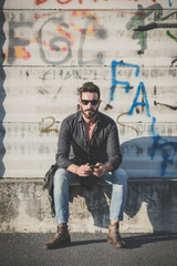 Wall Mural - young handsome attractive bearded model man using smartphone