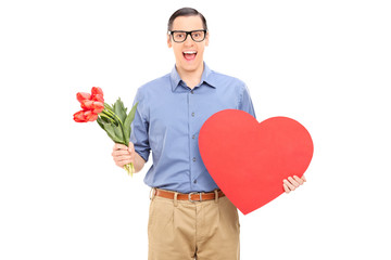 Wall Mural - Excited guy holding red heart and bunch of flowers