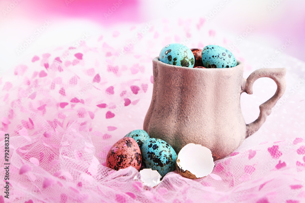 Bird colorful eggs in mug on bright background