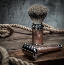 Safety Razor And Shaving Brush On A Wooden Background