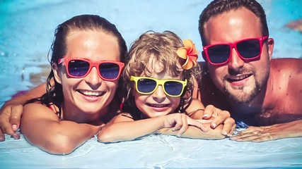 Poster - Happy family having fun in swimming pool. Slow motion