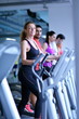 © .shock - woman exercising on treadmill in gym