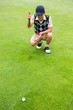 © WavebreakMediaMicro - Crouching golfer looking at the ball
