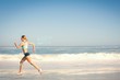 © WavebreakmediaMicro - Composite image of fit woman jogging on the beach