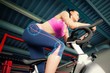 Determined young woman working out at spinning class