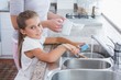 © WavebreakMediaMicro - Mother and daughter washing up
