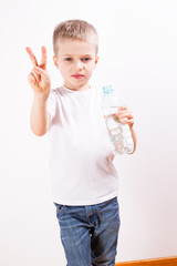 Young boy drinking mineral water