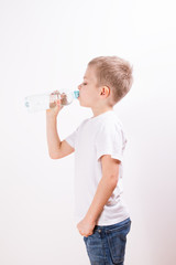 Young boy drinking mineral water