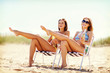 © Syda Productions - girls with drinks on the beach chairs