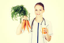 Doctor Holding Healthy Carrots And Juice.