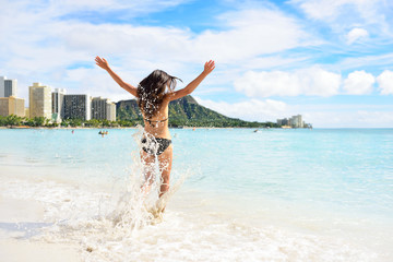 Waikiki beach fun - happy woman on Hawaii vacation