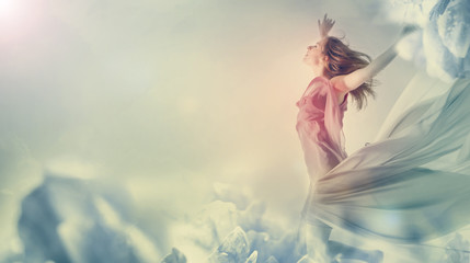 Beautiful woman jumping on a giant flower