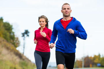 Healthy lifestyle - woman and man running