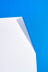 White piece of paper over a blue background.