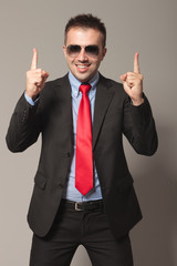 Poster - Haapy young business man holding two fingers up.