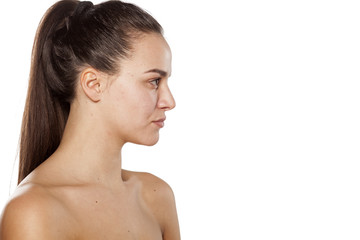 Wall Mural - Profile of a young woman on a white background