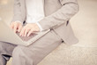 © Nonwarit - Businessman using laptop pc. He is sitting on a stairs.