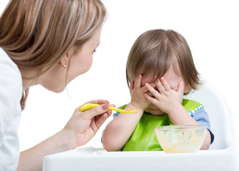 Wall Mural - Little boy refuses to eat closing face by hands