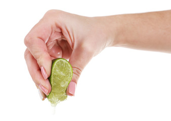 Wall Mural - Female hand squeezing lime isolated on white