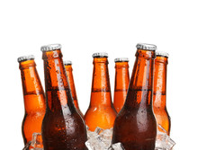 Glass Bottles Of Beer In Ice Cubes Isolated On White