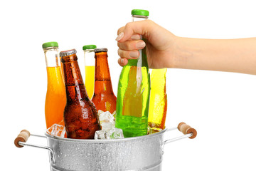 Canvas Print - Female hand taking bottle of drink from bucket isolated on white