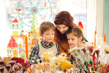 Mother With Happy Children In The Candy Store