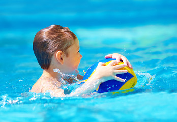 Wall Mural - cute kid playing water sport games in pool