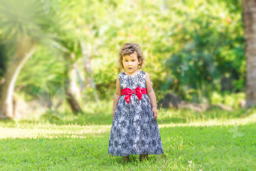 outdoor portrait of cute young child kid girl on natural green b