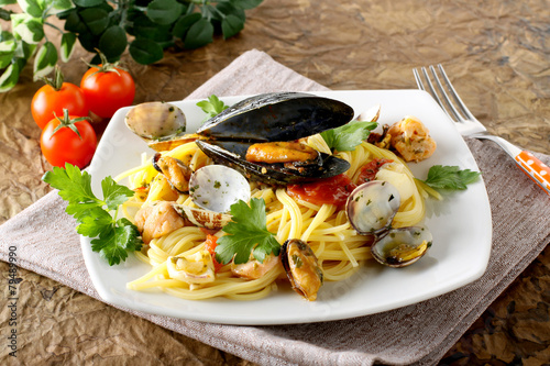 Fotografering Spaghetti with salmon, clams and mussels