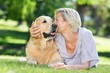 © WavebreakmediaMicro - Pretty blonde kissing her dog in the park