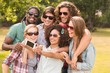 © WavebreakmediaMicro - Happy friends in the park taking selfie