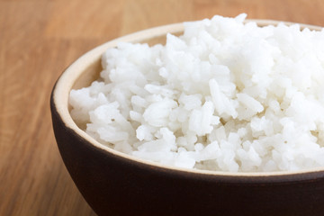 Wall Mural - Rustic bowl of white rice on wood surface. Detail.