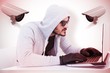 © WavebreakMediaMicro - Composite image of serious burglar hacking into laptop
