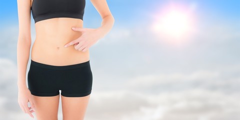 Poster - Fit woman with hand on stomach