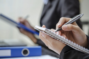 Closeup of business people writing