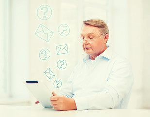 Wall Mural - old man with tablet computer at home