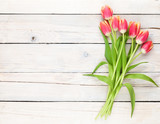 Fototapeta Tulipany - Colorful tulips on wooden table