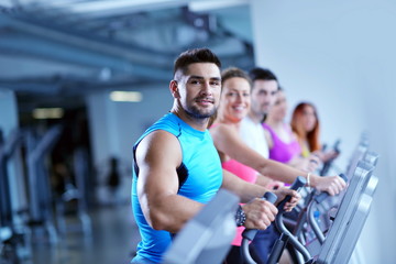 Wall Mural - Group of people running on treadmills